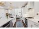 Stylish kitchen featuring an island with seating, stainless steel appliances, and modern finishes that opens to living spaces at 2359 Dogwood Dr, Erie, CO 80516