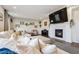 Comfortable living room featuring a cozy fireplace, a large sectional sofa, and stylish decor at 2359 Dogwood Dr, Erie, CO 80516