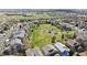 Aerial view of a vibrant neighborhood featuring a lush park with a playground at 2359 Dogwood Dr, Erie, CO 80516