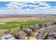 Aerial view of a suburban neighborhood with a golf course and a scenic waterway at 2359 Dogwood Dr, Erie, CO 80516