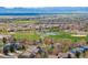 Scenic aerial view of a residential neighborhood with a park, baseball field, and mountain views at 2359 Dogwood Dr, Erie, CO 80516
