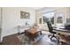 Cozy home office features hardwood floors, a large window, and stylish furnishings at 2359 Dogwood Dr, Erie, CO 80516