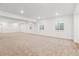 Expansive basement with recessed lights, neutral carpet, and natural light from windows at 8601 Yellowcress St, Littleton, CO 80125