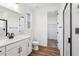 Bright bathroom featuring modern fixtures, a glass enclosed shower, and white cabinets at 8601 Yellowcress St, Littleton, CO 80125