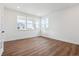 Bright bedroom with wood-look floors and large windows at 8601 Yellowcress St, Littleton, CO 80125