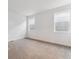 Bright bedroom with neutral walls, carpet, and natural light from dual windows at 8601 Yellowcress St, Littleton, CO 80125