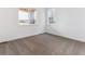 Bedroom with a neutral color scheme, carpet flooring, and bright windows at 8601 Yellowcress St, Littleton, CO 80125