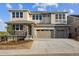 Two-story home with a three-car garage and modern stonework accents at 8601 Yellowcress St, Littleton, CO 80125