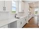 Kitchen with white cabinets, quartz countertops, and stainless appliances at 8601 Yellowcress St, Littleton, CO 80125