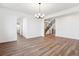 Open living room with hardwood-look flooring and staircase at 8601 Yellowcress St, Littleton, CO 80125
