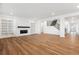 Spacious living room featuring wood-look floors, modern staircase, built-in shelving and fireplace at 8601 Yellowcress St, Littleton, CO 80125