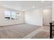 Upstairs living room featuring carpeting, lots of bright natural light, and a modern color scheme at 8601 Yellowcress St, Littleton, CO 80125