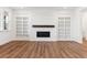 Living room featuring a fireplace with mantle and built-in bookshelves at 8601 Yellowcress St, Littleton, CO 80125