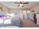 Bedroom featuring carpet, a ceiling fan, and access to an en-suite bathroom at 11207 Tumbleweed Way, Parker, CO 80138