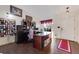 Bright home office with a large desk, built-in shelving, and natural light from the window at 11207 Tumbleweed Way, Parker, CO 80138