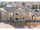 Exterior of a brown two-story home with three garage bays and gray roof shingles at 6412 Silver Mesa Dr # C, Highlands Ranch, CO 80130