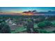 Scenic aerial view of a neighborhood at sunset showcasing expansive landscapes and mountain views at 12059 S Tallkid Ct, Parker, CO 80138