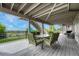 Covered back deck for entertaining with dining set, fence and mountain view at 12059 S Tallkid Ct, Parker, CO 80138