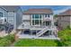 Back of house featuring spacious deck, sliding glass doors and beautifully maintained lawn at 12059 S Tallkid Ct, Parker, CO 80138