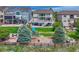 Landscaped backyard featuring a lush lawn, mature trees, a playground, with a large multilevel deck at 12059 S Tallkid Ct, Parker, CO 80138