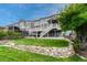 Lush backyard, featuring tiered landscaping, a spacious deck, and mature trees at 12059 S Tallkid Ct, Parker, CO 80138
