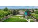 Large backyard features lush lawn, mature trees, playground and fenced perimeter at 12059 S Tallkid Ct, Parker, CO 80138