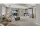 Finished basement with plush carpet, projector screen, comfy couch, and sliding glass door at 12059 S Tallkid Ct, Parker, CO 80138
