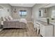 Comfortable bedroom with wooden floors, natural light and vanity with mirror at 12059 S Tallkid Ct, Parker, CO 80138