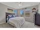 Gray bedroom with bed, two windows, ceiling fan, carpet, and shelves at 12059 S Tallkid Ct, Parker, CO 80138