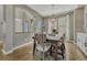 Dining room with hardwood flooring, modern light fixture, and view to the exterior at 12059 S Tallkid Ct, Parker, CO 80138