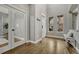 Bright entryway features hardwood floors, a vaulted ceiling, and natural light from two windows at 12059 S Tallkid Ct, Parker, CO 80138