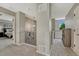Hallway with neutral carpet and paint, railing with black spindles and view of a bedroom at 12059 S Tallkid Ct, Parker, CO 80138