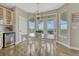 Bright breakfast nook boasts a modern light fixture and a table overlooking an exterior deck at 12059 S Tallkid Ct, Parker, CO 80138