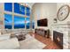 Vaulted great room has a fireplace, large windows, and modern furnishings at 12059 S Tallkid Ct, Parker, CO 80138