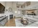 Stylish living room featuring a fireplace, modern furnishings, hardwood flooring, and a view to an upper loft at 12059 S Tallkid Ct, Parker, CO 80138