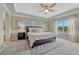 Spacious main bedroom features a tray ceiling, plush carpet, and bright windows at 12059 S Tallkid Ct, Parker, CO 80138