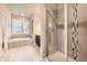 Tiled bathroom featuring both a bathtub and tiled glass shower at 5107 S Fairplay St, Aurora, CO 80015