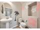 Charming powder room with pedestal sink and decorative wall art at 5107 S Fairplay St, Aurora, CO 80015