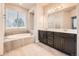 Bright bathroom with soaking tub and dual vanities at 5107 S Fairplay St, Aurora, CO 80015