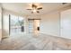 Bedroom with light carpet, a sliding barn door, and balcony access at 5107 S Fairplay St, Aurora, CO 80015