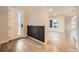Inviting foyer with decorative wall panel, hardwood floors, and a glimpse into the open-concept living space at 5107 S Fairplay St, Aurora, CO 80015