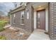 Close-up of the front entrance showcasing the brick exterior, the house number, and stylish front door at 5107 S Fairplay St, Aurora, CO 80015