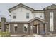 Charming two-story home featuring a brick facade, siding, covered entry, and a small balcony at 5107 S Fairplay St, Aurora, CO 80015