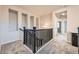 Upstairs hallway featuring neutral walls, plush carpet, and stylish light fixtures at 5107 S Fairplay St, Aurora, CO 80015