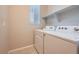 Bright laundry room with washer, dryer, window and shelf at 5107 S Fairplay St, Aurora, CO 80015