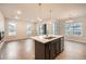 Open-concept living room and kitchen with hardwood floors and natural light at 5107 S Fairplay St, Aurora, CO 80015
