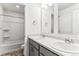 Bright bathroom featuring double sinks, modern fixtures, and a shower-tub combo with grey cabinets at 4635 Cattle Cross Trl, Castle Rock, CO 80104