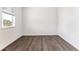Well-lit bedroom with neutral walls, laminate flooring, and a bright window at 4635 Cattle Cross Trl, Castle Rock, CO 80104