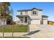 Charming two-story home with a welcoming front porch and a well-manicured lawn at 4635 Cattle Cross Trl, Castle Rock, CO 80104
