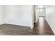 Bright hallway featuring laminate wood flooring and white walls, creating a clean aesthetic at 4635 Cattle Cross Trl, Castle Rock, CO 80104
